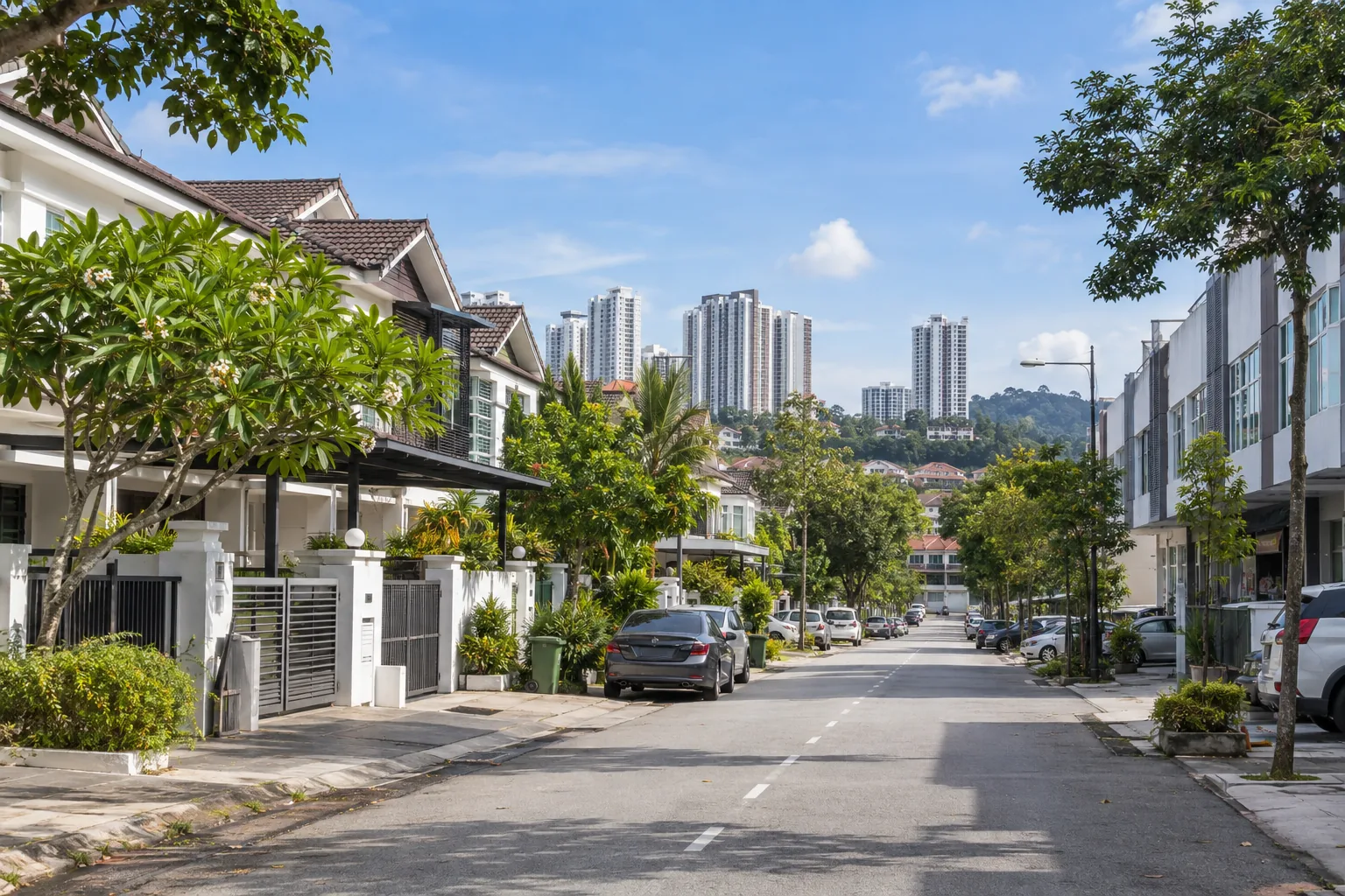 quiet residential street in Puchong with parked cars and trees under a blue sky